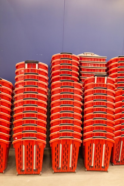 Lots of empty shopping baskets stacked in the supermarket