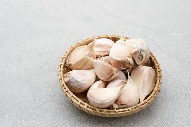 Lots of fresh garlic on grey background Close up Selected focus