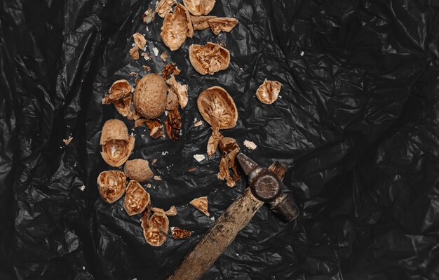 Lots of fresh nuts on a black wooden background. Best practices for designer