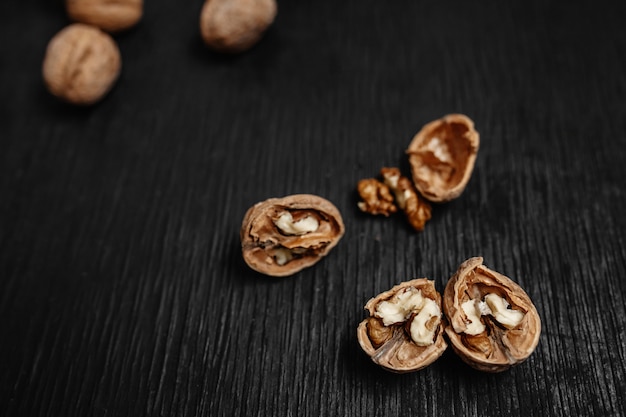 Lots of fresh nuts on a black wooden background. Best practices for designer