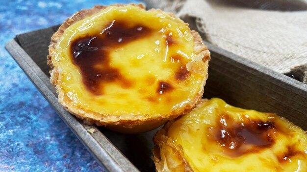 Lots of freshly baked desserts Pastel de nata or Portuguese egg tart Pastel de Belm is a small pie with a crispy puff pastry crust and a custard cream filling A small dessert a cupcake