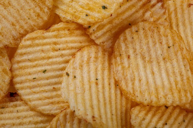 Photo lots of potato chips texture close up