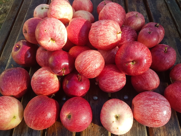 Lots of red apples on the wooden table