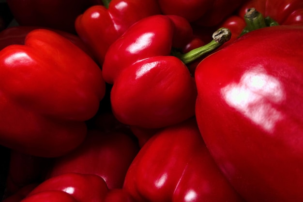 Lots of red bell peppers close up