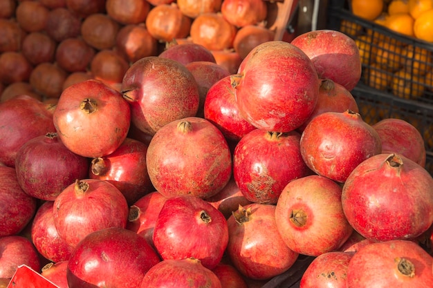 Lots of red pomegranates on the counter