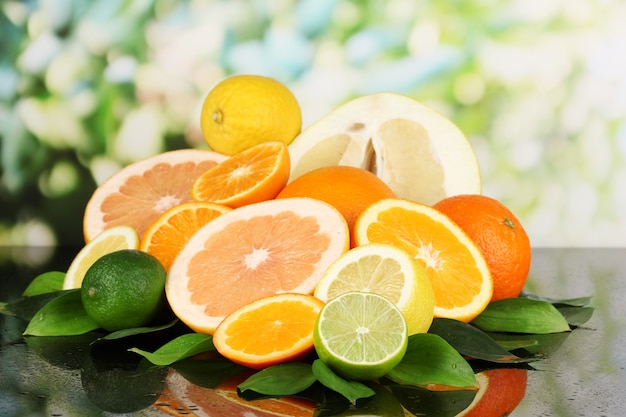 Lots ripe citrus on black table on natural