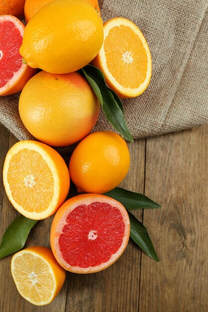 Lots ripe citrus on wooden background