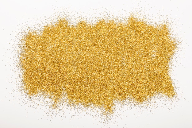 Lots of shiny gold sequins on a white background.