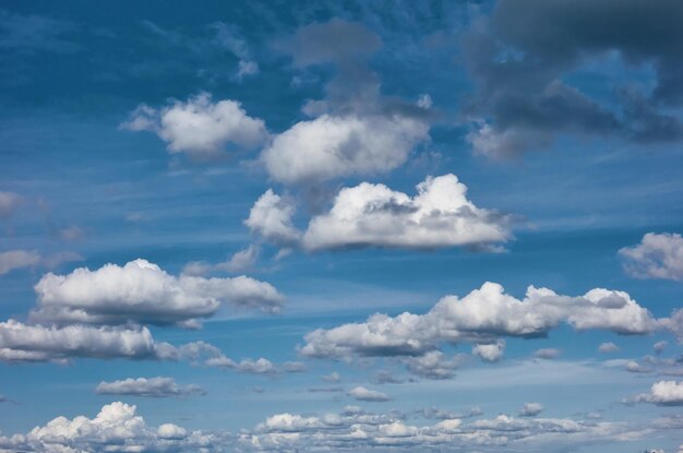 Lots of white and gray clouds on the blue sky for a natural\
background