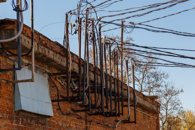 Lots of wires sticking out of an old brick electrical substation building