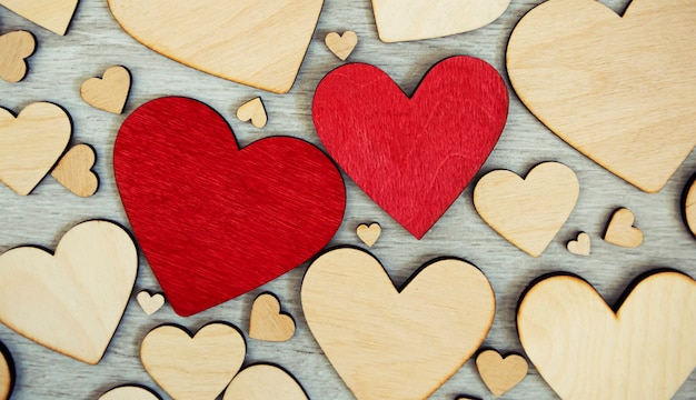 Lots of wooden hearts on the wooden table