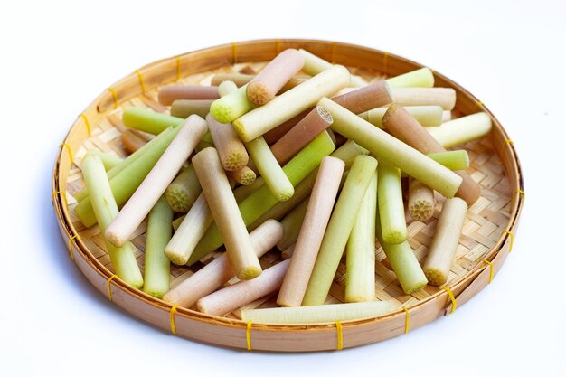 Lotus stems in bamboo plate on white background