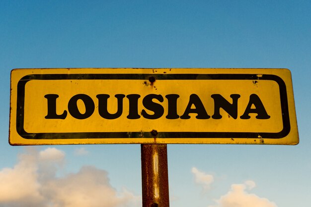 Louisiana state on old yellow sign with blue sky 