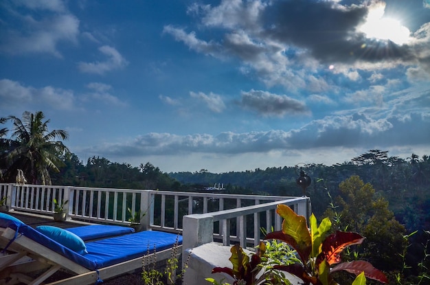 Lounge chairs at building terrace against sky