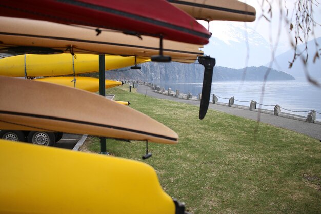 Lounge chairs on field by sea