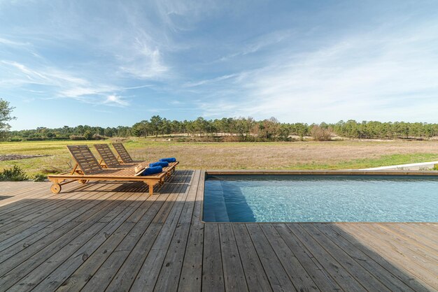 Photo lounge chairs in modern villa pool