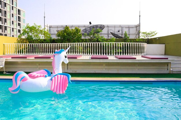 Lounge chairs in swimming pool against clear sky