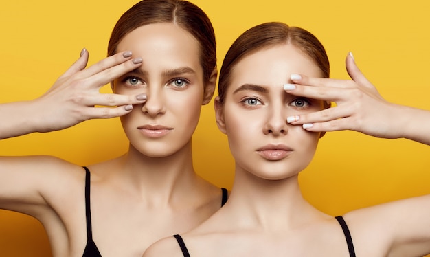 Lovable two caucasian girls expressing positive emotions