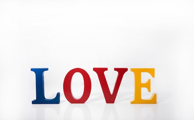 Love colored wooden letters on white background.