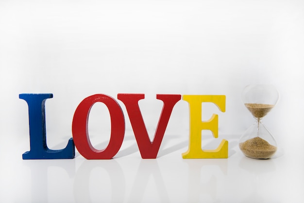 Photo love colored wooden letters on white background.