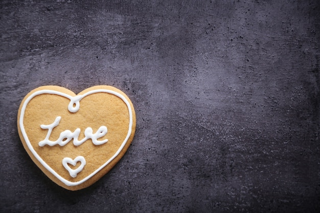 Love cookie on dark background, copy space