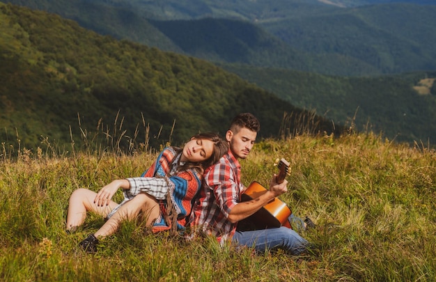 Love couple camping and enjoying picnic on sunny day summer vacations