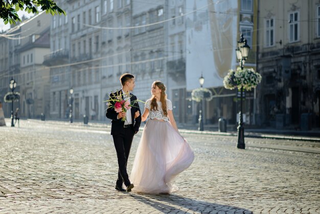 In love couple embracing each other in street