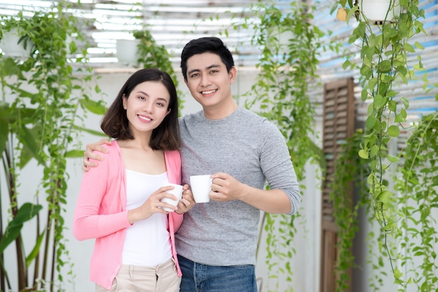 Love couple at home.  Young asian relaxing on a balcony's garden.