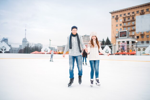 Love couple learn to skate on the rink