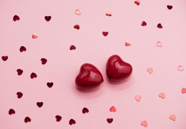 Love emotion hearts confetti and two hearts valentines day\
concept viva magenta color trend 2023