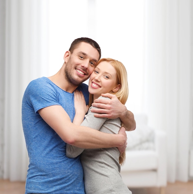 Love and family concept - smiling couple hugging