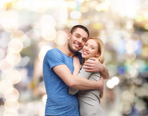 love and family concept - smiling couple hugging