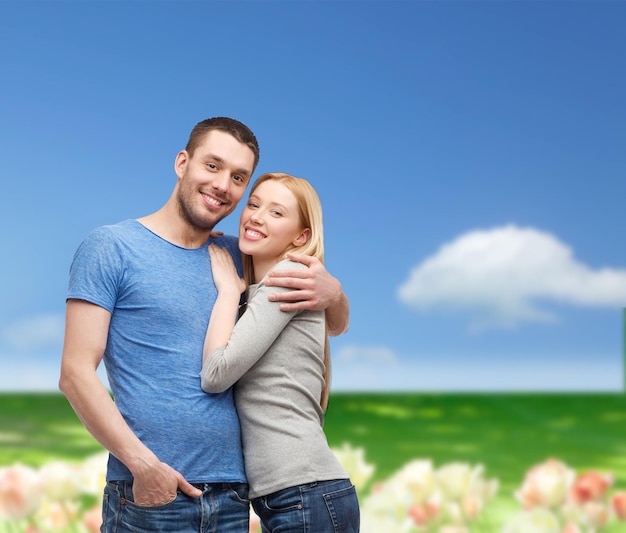 love and family concept - smiling couple hugging