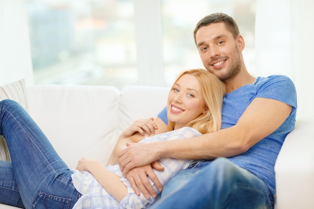 love, family and happiness concept - smiling happy couple at home