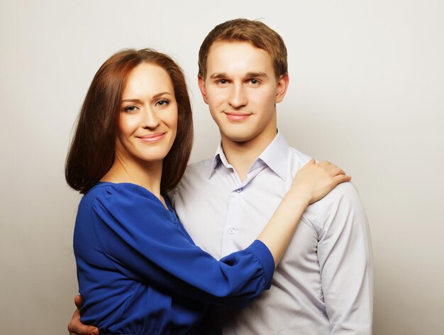 Love family and people concept lovely happy couple hugging over grey background