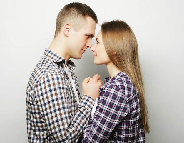 Love family and people concept lovely happy couple hugging over grey background