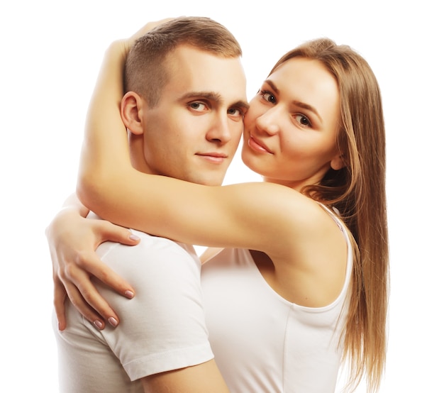 Love, family and people concept: lovely happy couple hugging over white background.