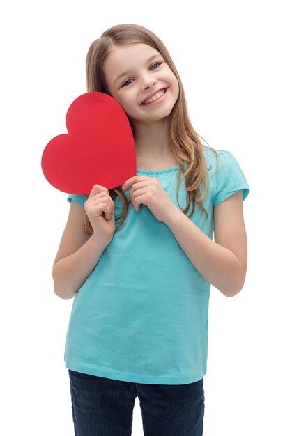 love, happiness and people concept - smiling little girl with red heart