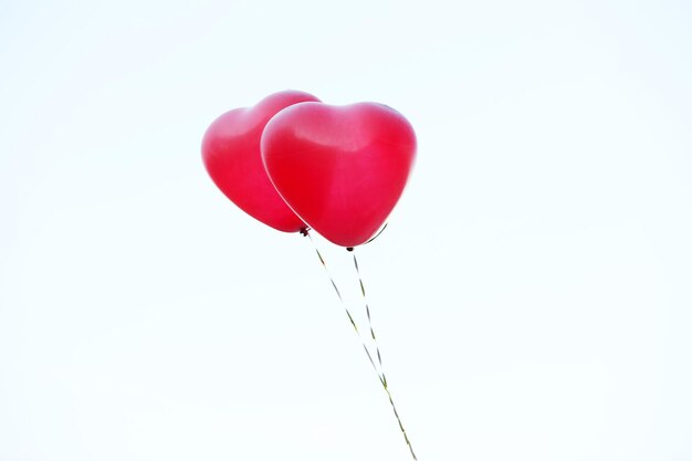 Love heart balloons on sky background