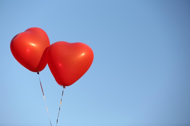 Love heart balloons on sky background