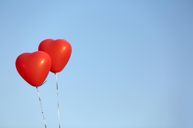 Love heart balloons on sky background