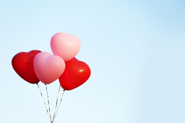 Love heart balloons on sky background