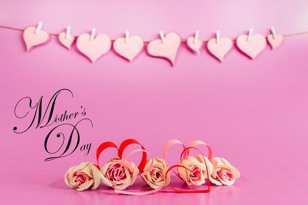 Love hearts and roses on pink background