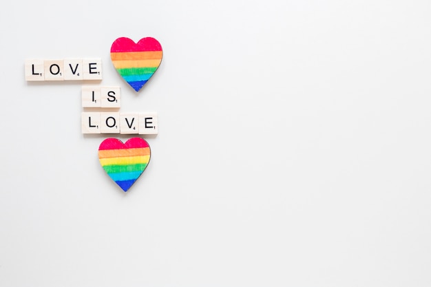 Love is love inscription with two rainbow hearts