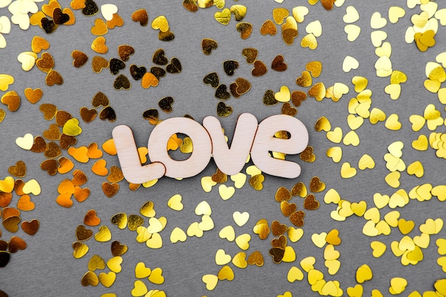 Love is a yellow heart on a gray table on Valentine's Day.