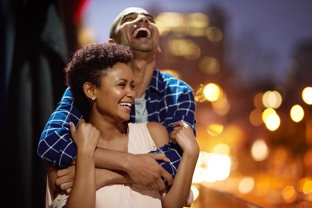 In love and laughter Cropped shot of an affectionate young couple out on a date in the city