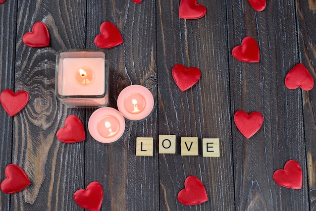 Love letters on the table Heart love candle with flame Postcard wallpaper banner background