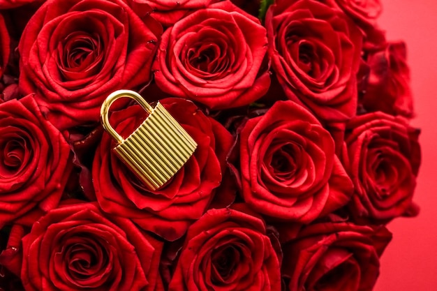 Love lock for Valentines Day card golden padlock and luxury bouquet of roses on red background