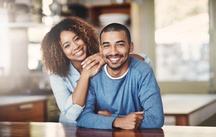 Photo love marriage and portrait of happy couple in kitchen of home with smile embrace and healthy relationship happiness man and woman with pride affection and romance young people in new apartment