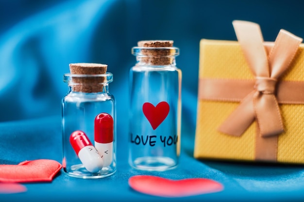 Love medicine. I love you .Tablets in jars are kissing, Happy Valentine's Day, Mother's Day, March 8, World Women's Day holiday card concept. Flat lay.